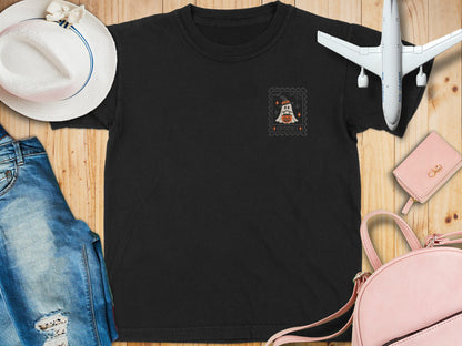 Black t-shirt with a ghost and pumpkin stamp graphic reading "SPOOKY".